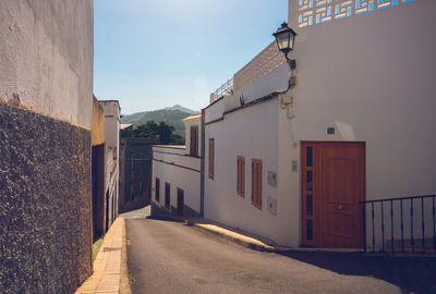 Street amidst buildings against sky