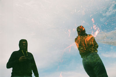 Low angle view of man standing against sky