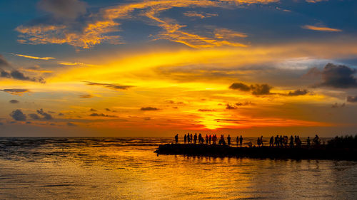 Scenic view of sea against orange sky