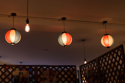 Low angle view of illuminated lanterns hanging from ceiling