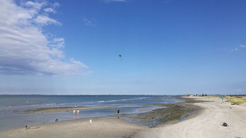 Scenic view of beach against blue sky