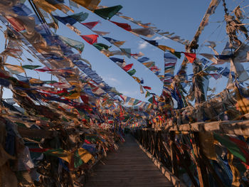 Low angle view of flags hanging against sky