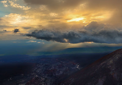 Scenic view of dramatic sky over landscape during sunset