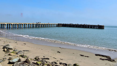 Scenic view of beach against clear sky