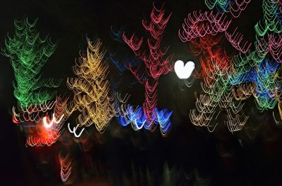 Low angle view of illuminated lights at night