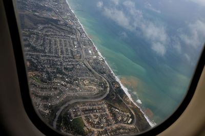 Aerial view of landscape seen through airplane window