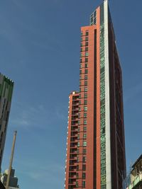 Low angle view of modern buildings against blue sky