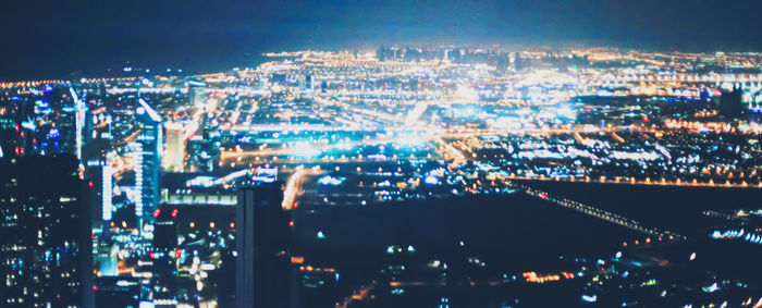 Aerial view of city lit up at night