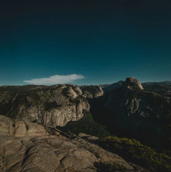 Scenic view of mountains against blue sky