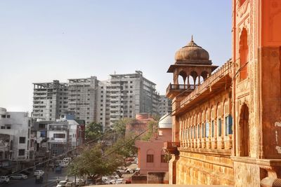 Buildings in city against clear sky