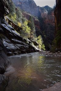 Scenic view of river amidst mountains