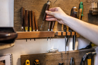 Unrecognized caucasian young craftswoman making guitar. high quality photo