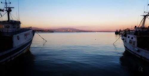 Sailboat in sea at sunset