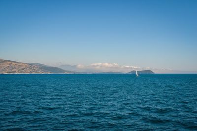 Scenic view of sea against clear blue sky