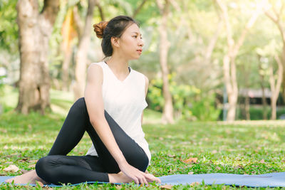 Young woman sitting on grass