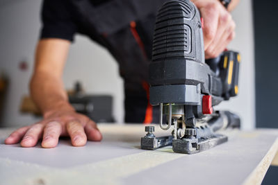 Midsection of man working in workshop