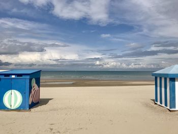 Lifeguard hut on beach against sky