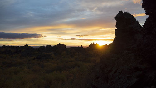 Scenic view of silhouette mountains against sky during sunset