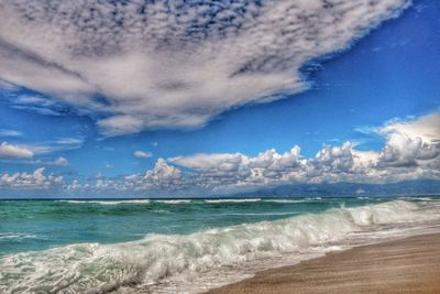 Scenic view of sea against cloudy sky