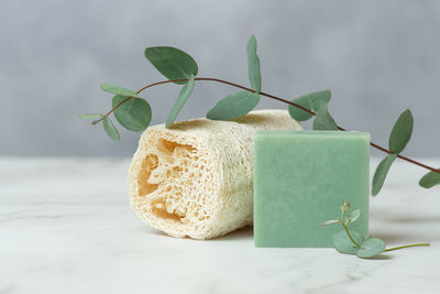 Accessories for body care made of natural materials on a green background. 