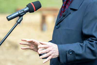 Politician or business person is giving a speech at media event or news conference