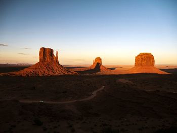 Rock formations in desert during sunset