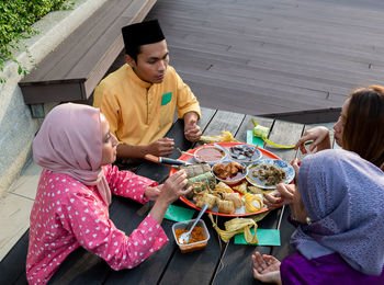 Midsection of woman holding food in restaurant