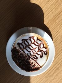 Directly above shot of cappuccino served on table