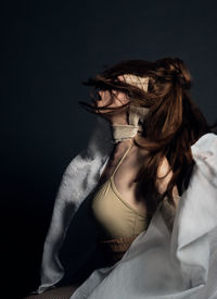 Midsection of young woman against white background