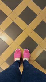 Low section of woman standing on tiled floor