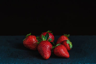 Still life of red strawberries on a slate board