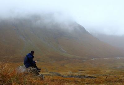 Rear view of man standing on mountain