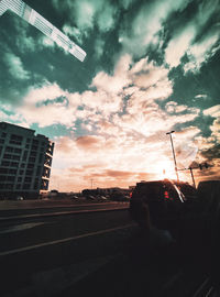 Low angle view of silhouette buildings against sky during sunset