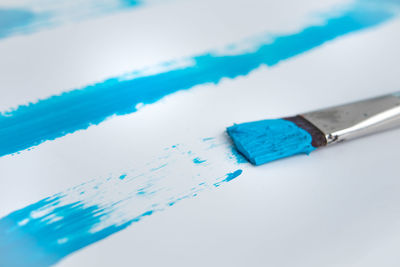 High angle view of blue paint on white background