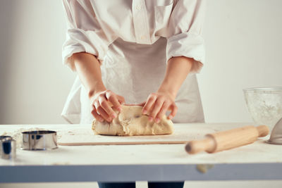 Midsection of woman preparing food at table