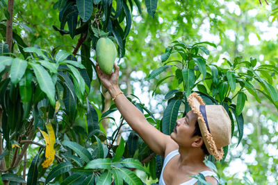 Portrait of woman holding plants
