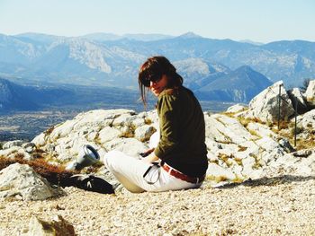 Woman sitting on mountain