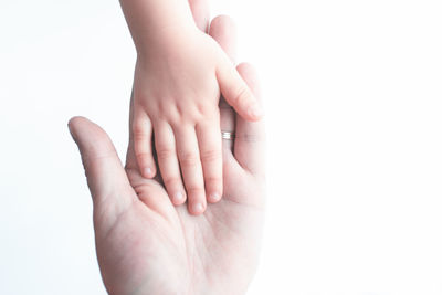 Close-up of hands over white background