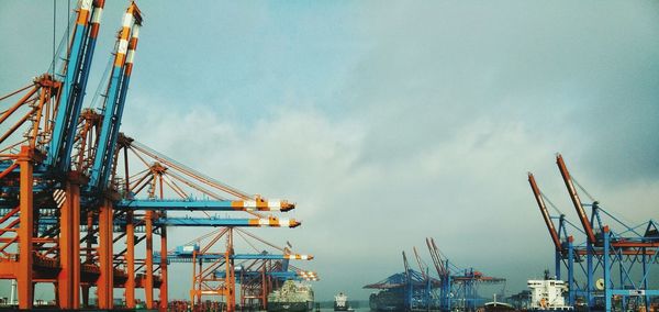 Low angle view of cranes at construction site