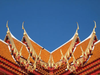 Low angle view of traditional building against clear blue sky