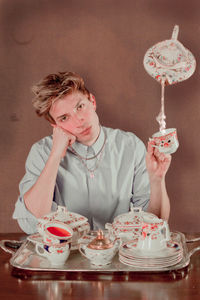 Portrait of woman with chocolate cake on table