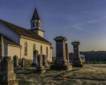 View of cemetery and building against sky