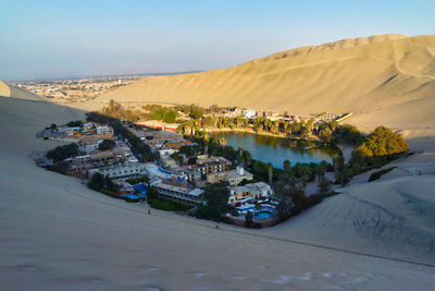 Panoramic view of buildings and mountains against sky