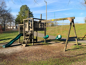 Playground in park against blue sky