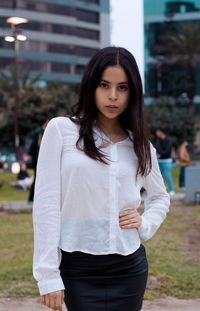 Portrait of young woman standing outdoors