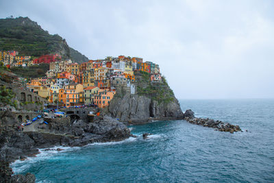 Scenic view of sea and buildings against sky