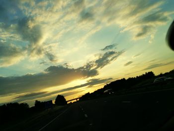 Cars on road at sunset