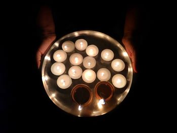High angle view of human hand holding candle