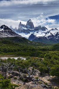 Scenic view of mountains against cloudy sky