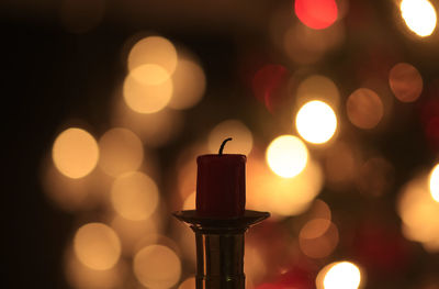 Close-up of illuminated candles against blurred background